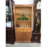 A solid pine open bookcase on cupboard/drawer base