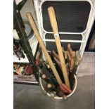 A bucket of garden tools & wood saws