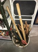 A bucket of garden tools & wood saws