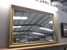 A large gilt framed bevel edged mirror