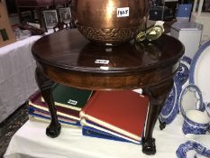 A small round mahogany coffee table.