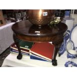 A small round mahogany coffee table.