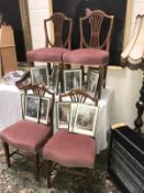 A set of 4 mahogany shield back dining chairs with pin draylon seats.