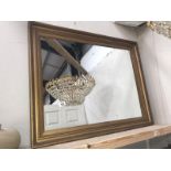 A large gilt framed mirror.