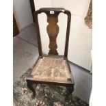 An Edwardian oak high backed chair.