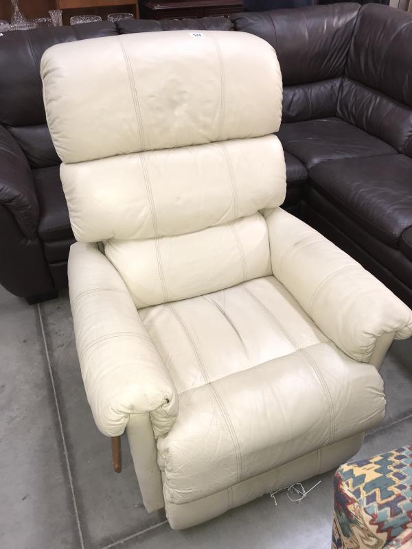 A cream leather recliner chair