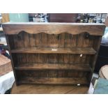 A dark stained pine kitchen shelf.