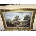 A large gilt framed print of countryside.