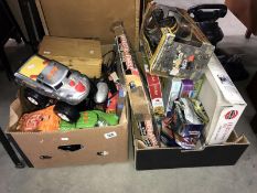 2 boxes of games, toys & puzzles including toy cars, helicopter, slot racing car set etc.
