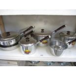 A quantity of vintage stainless steel saucepans
