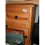 A solid pine bedside cabinet