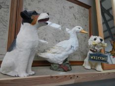 2 dogs and a duck sculpture