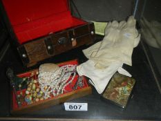 A jewellery box including costume jewellery, compact, silver handled nail tool,