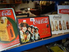 A quantity of Coca Cola signs