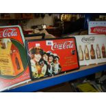 A quantity of Coca Cola signs