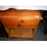 An old pine bedside cabinet