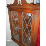 An Edwardian oak hanging cabinet