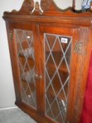 An Edwardian oak hanging cabinet