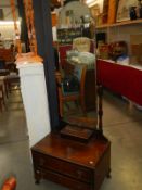 A mahogany mirror on stand