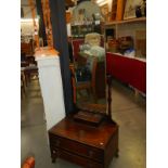 A mahogany mirror on stand