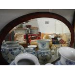 A good mahogany framed oval bevelled mirror