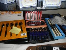 A quantity of boxed knife and spoon sets and other cutlery