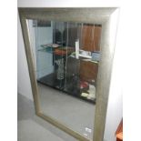 A silvered rectangular mirror