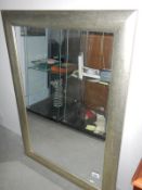 A silvered rectangular mirror