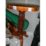 A mahogany tripod side table