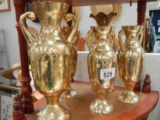 A collection of brass vases