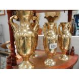 A collection of brass vases