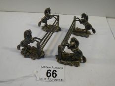 An unusual pair of pewter knife rests being horses jumping fences.