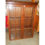 A good oak 2 door bookcase, high, in good condition.