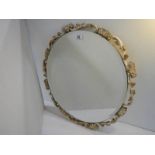 A carved wood guesso and guilded bevel edged circular mirror, no damage.