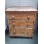 An antique 3 drawer pine chest on bun feet,