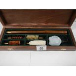 A cased gun cleaning kit, complete.
