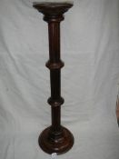 A mahogany torchere,