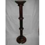 A mahogany torchere,