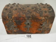 An early Victorian hide covered dome topped glove box with copper mounts, hide a/f.