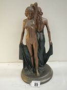 An art deco style figure of a semi nude and a nude lady, 12.5" tall.