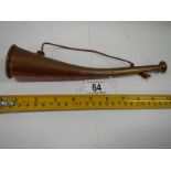 An old copper hunting horn in good condition.