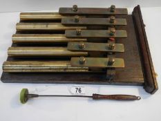 An unusual brass 5 key xylophone with brass bell tubes,