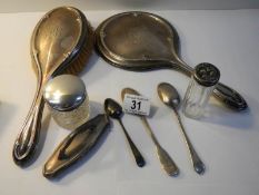 A silver dressing table set and 3 silver spoons (8 items in total).