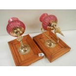 2 vintage bedside wall lamps with red shades.