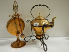 A Victorian brass kettle on stand and an early 20th century brass dinner gong.