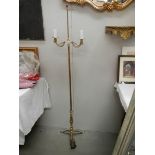 A 20th century brass standing lamp in gilded rope design, 60" tall and in good condition.