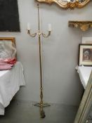 A 20th century brass standing lamp in gilded rope design, 60" tall and in good condition.