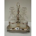 A Victorian 3 bottle tantalus complete with decanters, in good condition.