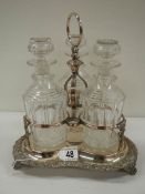 A Victorian 3 bottle tantalus complete with decanters, in good condition.