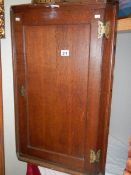 A Victorian oak hanging corner cupboard.